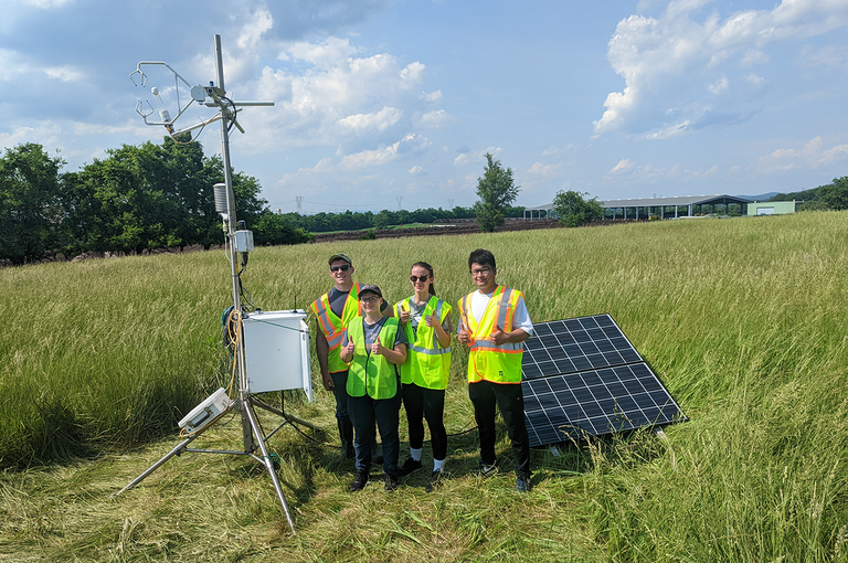 Miles - students in field with tower 2022-small.png